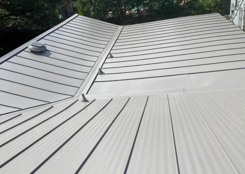 Solar attic fan installed on a metal roof for Roof Ventilation in Page